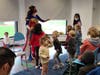 Wonder Woman leads children in a game of freeze dance.