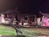 A fire destroyed a Camden County home and extended into the house next door, officials said.