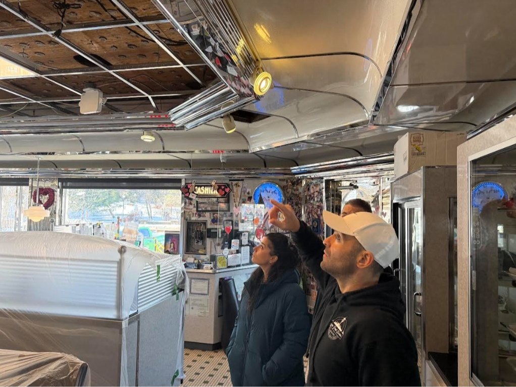 Meadows Diner owners and operators Amy Liatos, Evan Liatos and Nick Hionas examine the restaurant renovations.