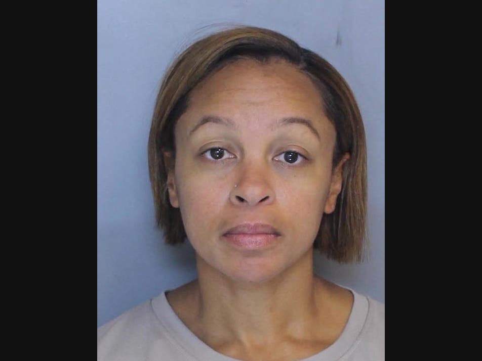 A Lower Merion School Board member facing theft charges related to her former employer has resigned.