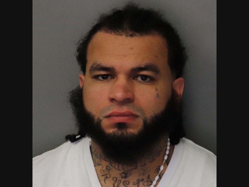 A man accused of stabbing another driver after a crash on the Main Line this weekend was wanted for an armed robbery four years ago at a Delaware county convenience store, authorities said.