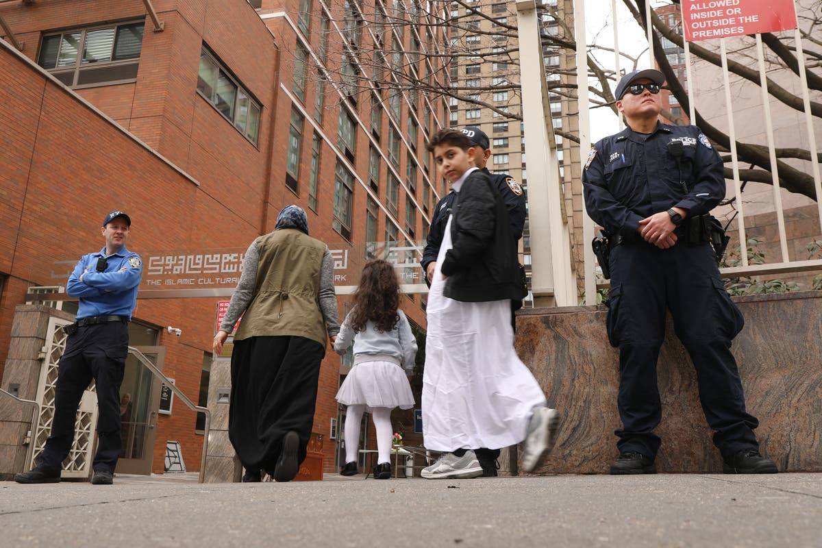 New York City police officers stand outside of a mosque in Manhattan following the mass shootings at two mosques in NZ.