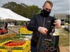 Tyler Hagmaier, Assistant Category Manager of Produce for Stop & Shop, fills produce to donate to local families in need at Young Family Farm in Little Compton.