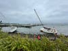 High surf pulled sailboats onto the shore along the coast in Jamestown, Rhode Island. 