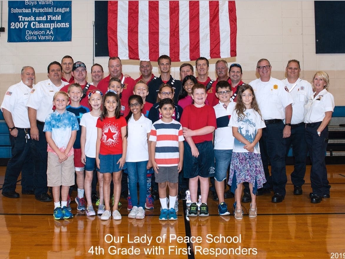Students from each grade, 4th pictured, met with local police and fire personnel