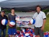 Curt Suraci, Tyler Monte and Steve Monte handing out beach balls