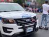Two different incidents in the East Village left an e-biker hit by a cop car and a teen slashed in the face, cops said.
