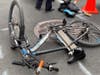 Two different incidents in the East Village left an e-biker hit by a cop car and a teen slashed in the face, cops said.
