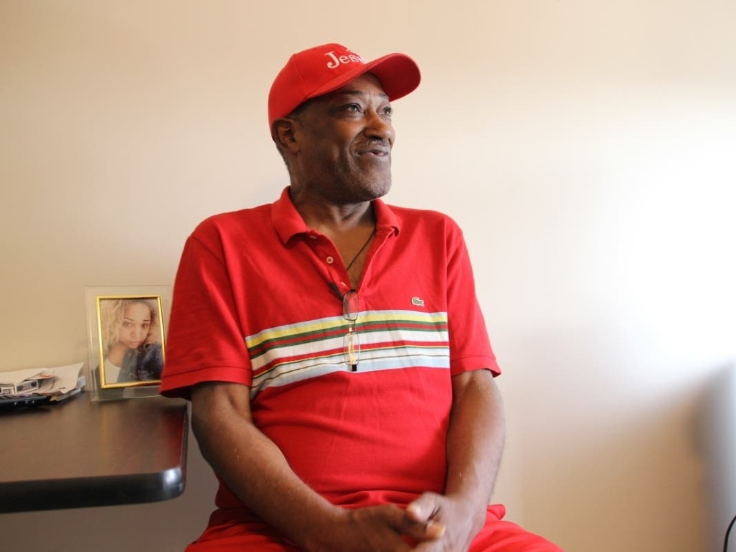 Robert Offley, 64, sits in his apartment in the Bronx next to a photo of his daughter.