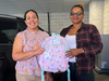 From left, Cristina Hernandez, ImageFIRST Human Resources Generalist, shares backpacks with Lourdes Duarte-Daluz, Resident Services Coordinator, Building Neighborhoods Together