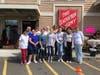 Community volunteers come together to distribute school supplies and backpacks to local children in need. 