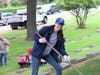 Volunteers bring rakes, buckets, and gloves to remove fallen pine needles, and grass clippings from the cemetery 
