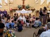 Canon Mitchell receiving a gift from the children of Saint David’s on her last day as full-time Rector of the Parish.	