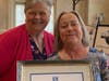 Marguerite Brambani accepts the Partner of the Year Award for Jack Lyons, owner of
 Neshaminy Electrical Contractors, Inc., from Gina Fuscellaro, SIIR fundraising chair.
