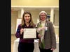 Dr. Samantha Gross accepts the Advancing the Status of Women Award for Bucks County Community College from Jenny Lichtner, SIIR president.