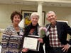 Dorothy Gaboda accepts the Women Helping Women Award from Kathy Meyer, past SIIR president, with her husband, Bill.