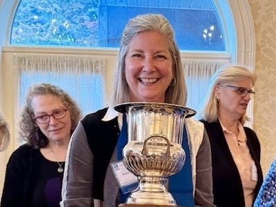 Jenny Lichtner, SIIR president, holding the Governor’s Cup presented at the NAR Spring Conference
