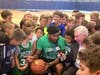 Boston Celtics guard Marcus Smart draws a crowd for a WBZ-TV interview at his basketball camp in Waltham.