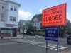 A Teele Square sign warns Broadway is shut down one mile ahead due to the Green Line Extension Project.