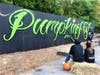 Milford artist Eric Escobar paints an evolving "Pumpinfest" mural during this weekend's 30th annual Milford Pumpkin Festival.