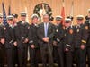 Chief Glenn Quick accepts his official fire chief helmet and certificate of promotion on Tuesday.