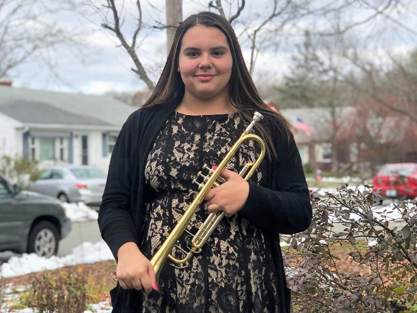 Sophomore Lily Bolarinho plays national anthem on her trumpet for East Providence first responders, Linn Health and Rehabilitation nurses.