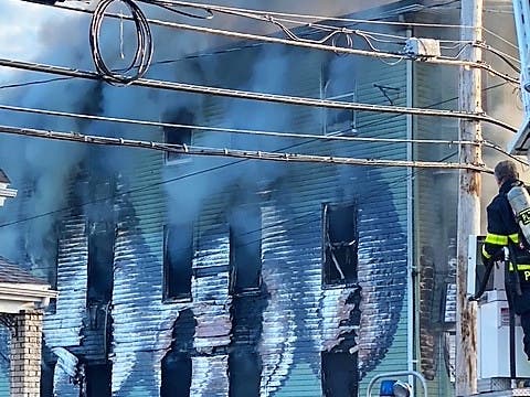 Crews work to cool hot spots after a fire destroyed a long-abandoned home on Warren Street in Peabody.