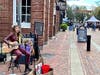 North Shore musician Callie Hughes performs on Essex Street in Salem ahead of Thursday's Grand Parade.