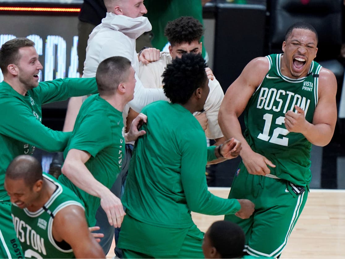 Boston Celtics forward Grant Williams (12) celebrates with his teammates after defeating the Miami Heat in Game 7 of the NBA basketball Eastern Conference finals playoff series, Sunday, May 29, 2022, in Miami. 