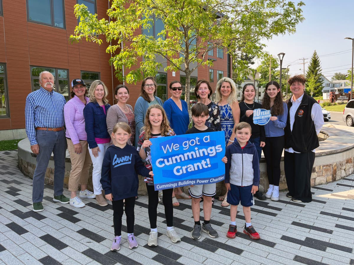 Beverly Education Foundation board members and Beverly Public Schools students celebrate the $300,000 grant award at the Beverly Middle School. 