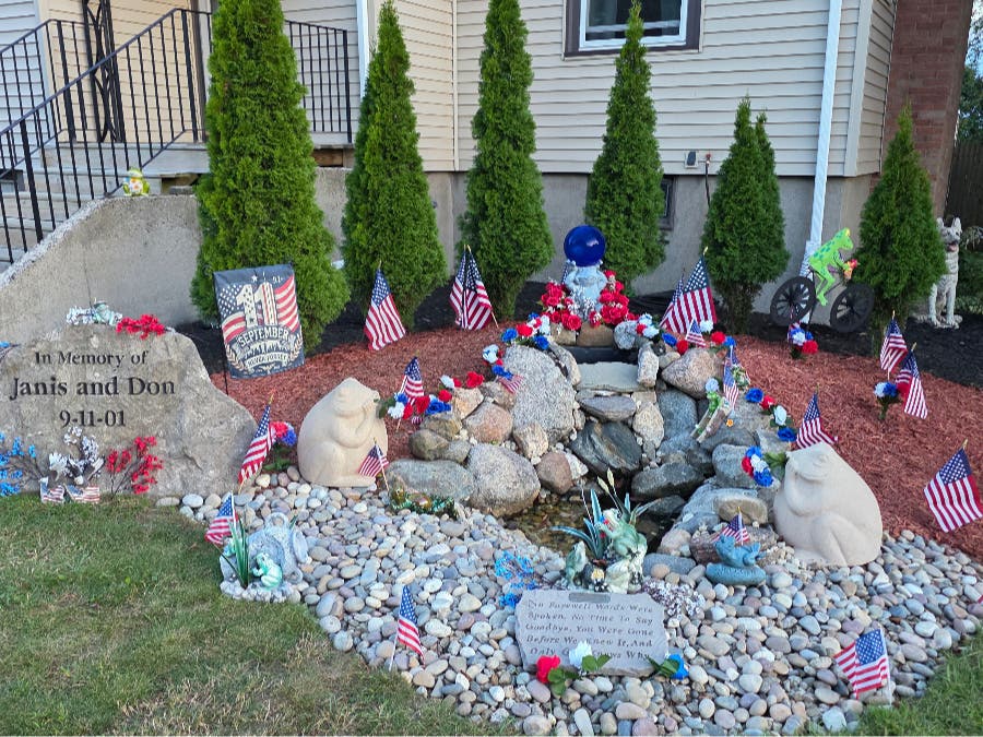 A 9-11 memorial in memory of Janis Lasden and Don DiTullio stands at the Peabody home of Janis's sister, Linda LeBlanc, ahead of the 25th anniversary of the terrorist attacks.
