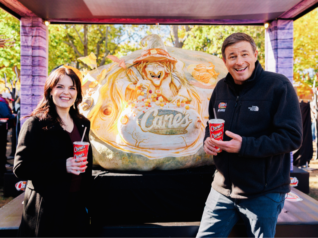 Raising Cane’s owner and founder Todd Graves and "Halloweentown" star Kimberly J. Brown with the new world-record 3,156-pound jack-o'-lantern on Salem Common.
 