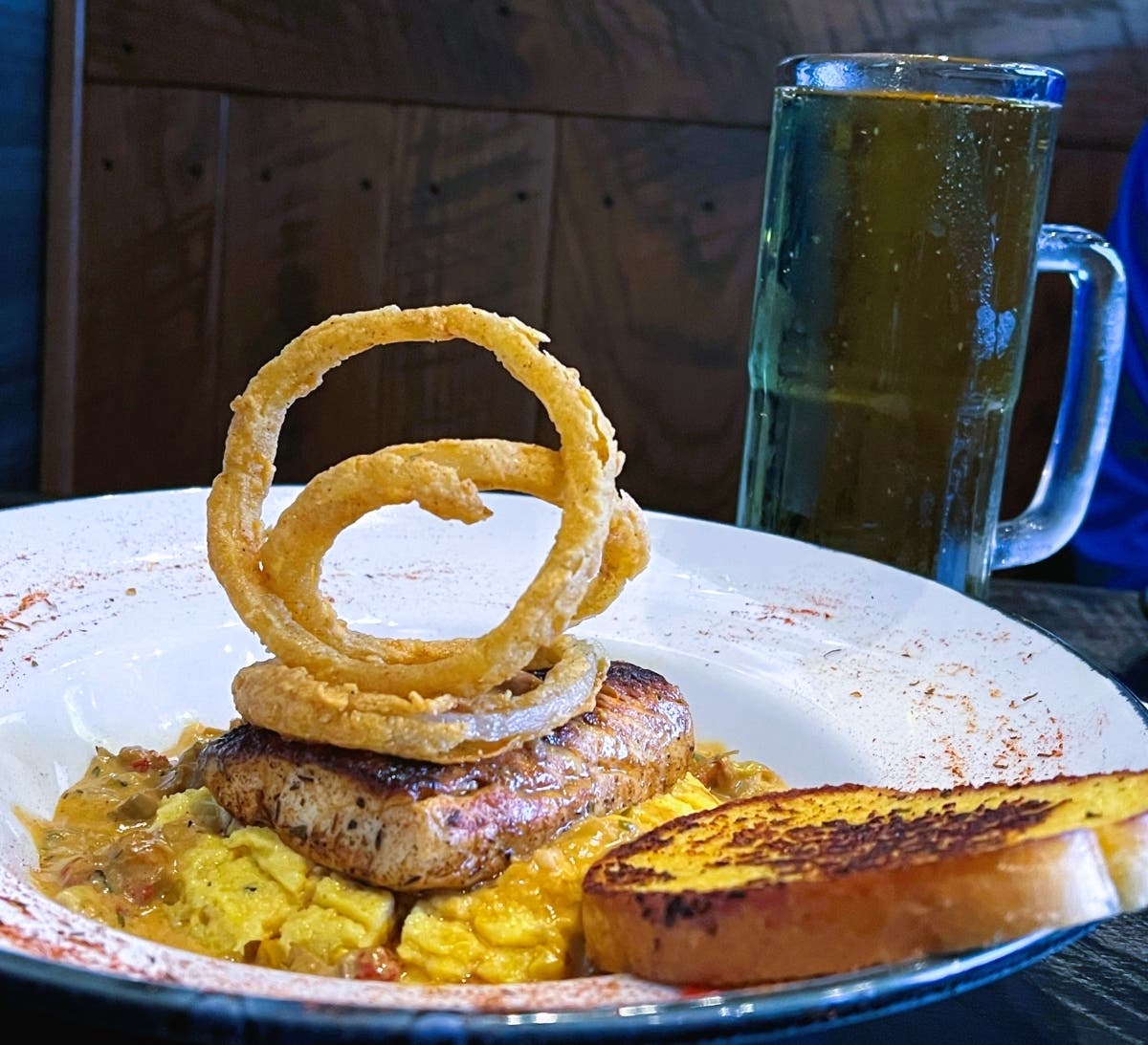 Mardi Gras Mahi includes blackened mahi, crawfish mushroom sauce, corn grits and onion strings.