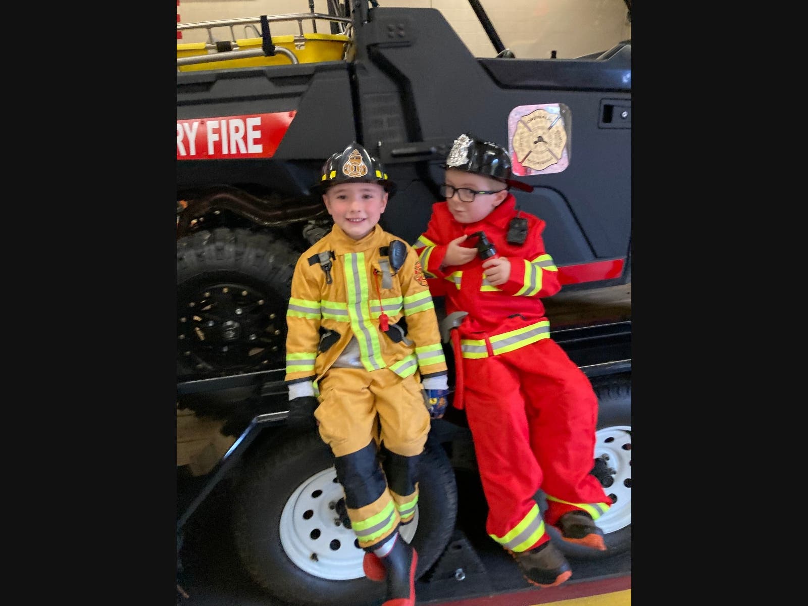 Henry Hatstat (left) and Cooper Hutter, both five years old, enjoy the community party Sunday October 11th to 'Wet Down' two new fire trucks.