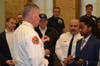 Fire Chief Robert Edgar gives Jaden Martin-Burgess a Fire Challenge Coin.