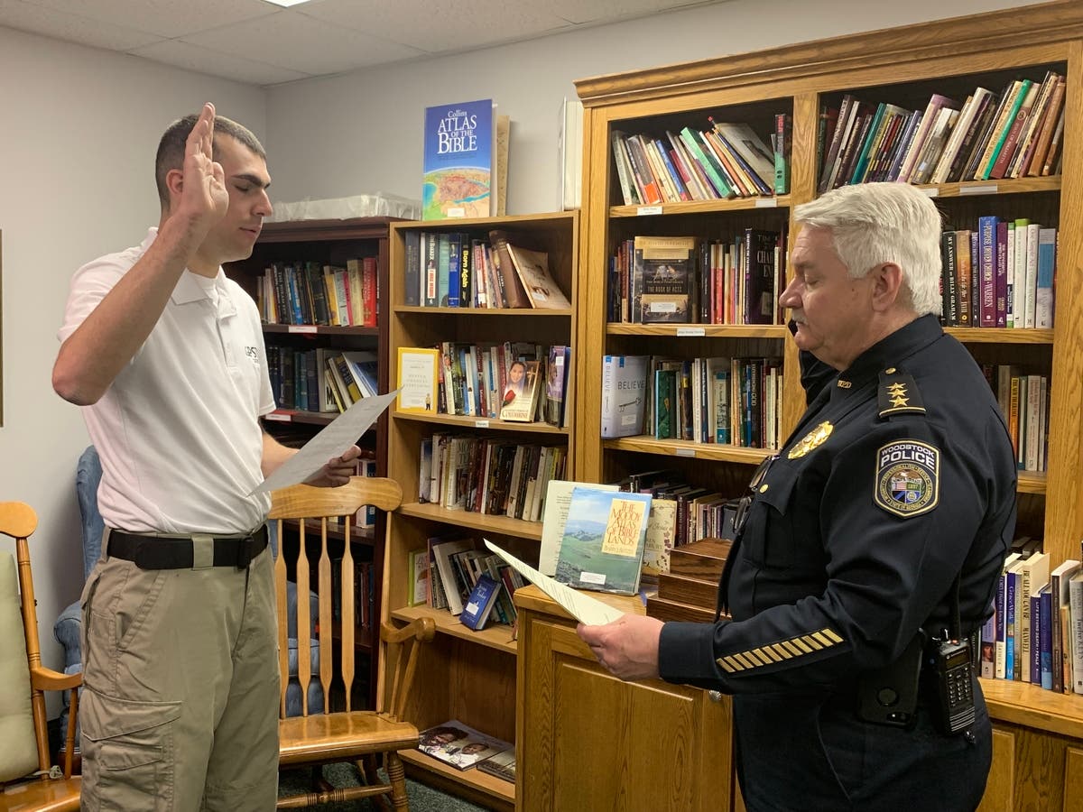 Officer Justin Ismach is sworn in by Chief Calvin Moss shortly after his graduation in Pickens County.