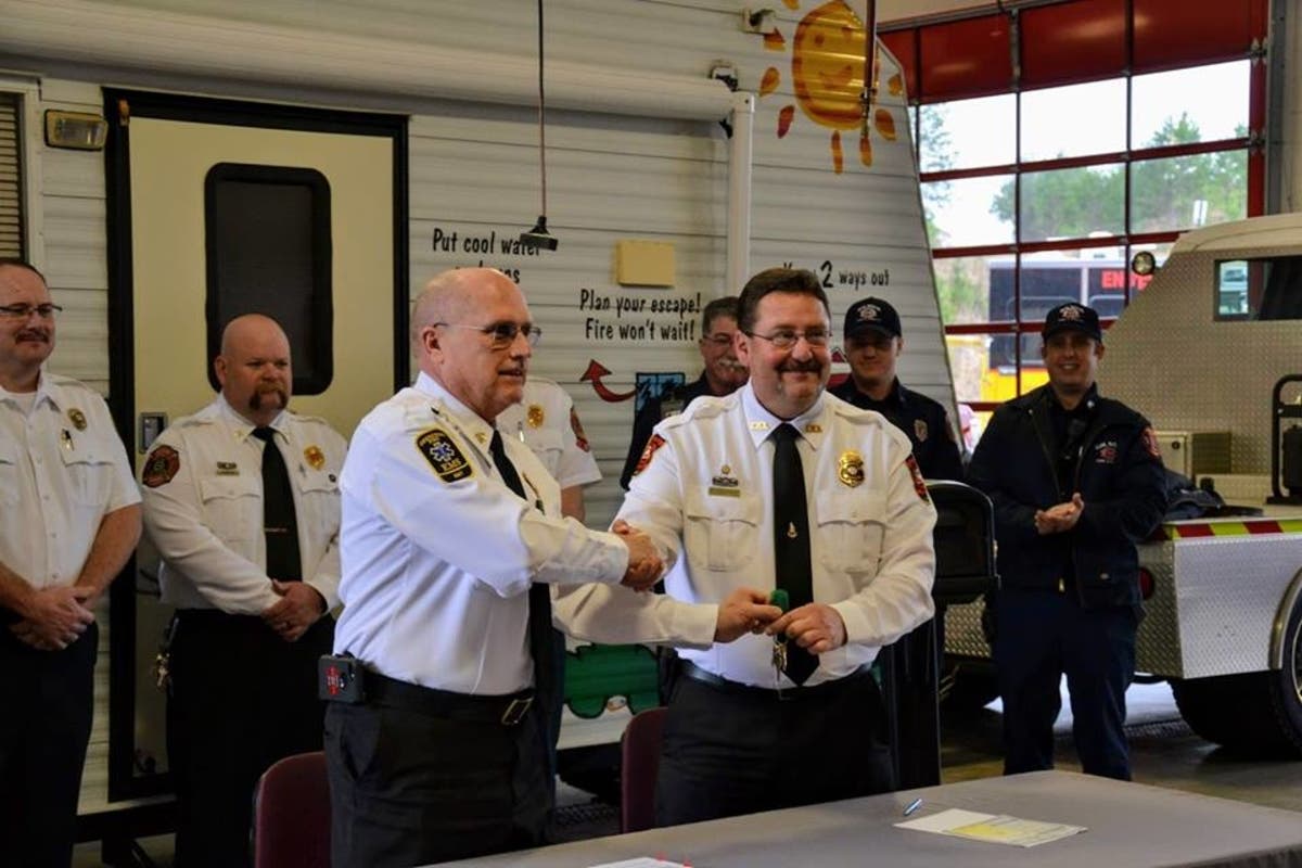 Cherokee County Fire Chief Tim Prather, left, shakes hands with Gilmer County Public Safety Director Keith Kucera.