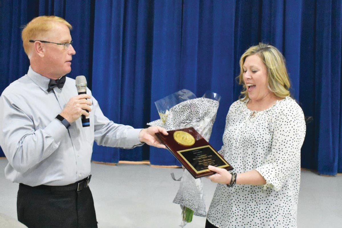 Cherokee Superintendent Brian Hightower presents the Game Changer Award to Amy Loiselle.