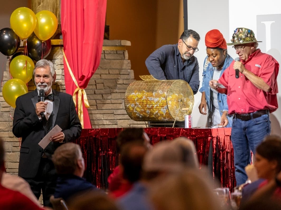 The popular 2019 Reverse Raffle generated a record amount of funds to help Chattahoochee Tech students in need. Shown here, l-r, are Mark McCain, Chattahoochee Tech students Rafael Garate and Kaya Smith, and Louis Tonsmeire.