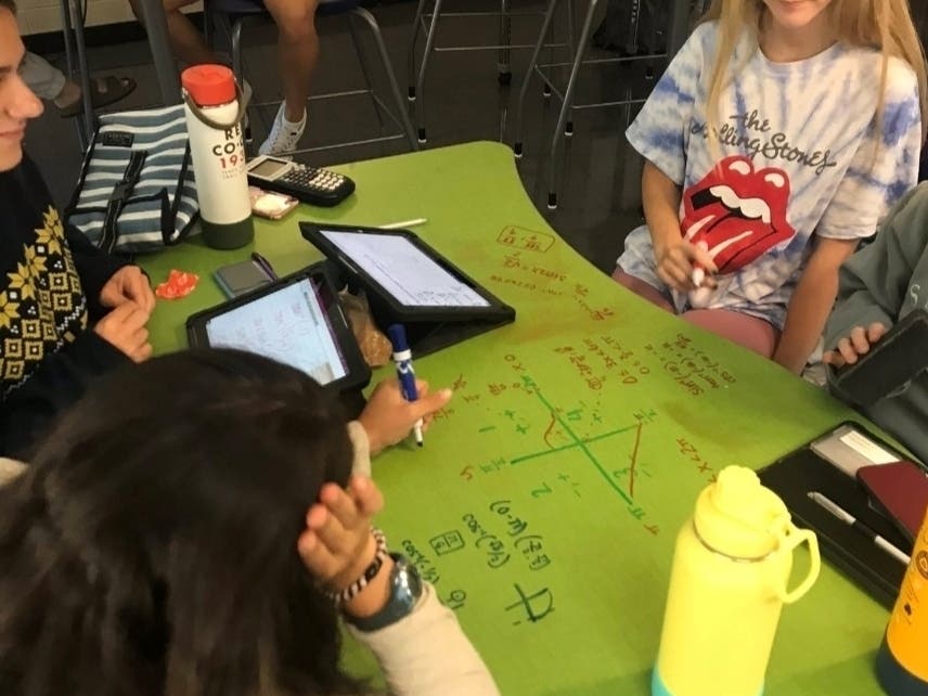 Students and tutors working together to solve math problems in the Raider Math Center.