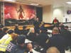 Cherokee County law enforcement and public safety officers participate in a post-drill meeting in the Cherokee High School cafeteria after the multi-agency emergency response drill on Thursday.