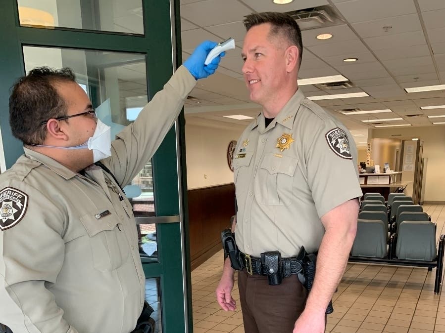 Cherokee Sheriff Frank Reynolds gets his temperature taken as a coronavirus precautions.