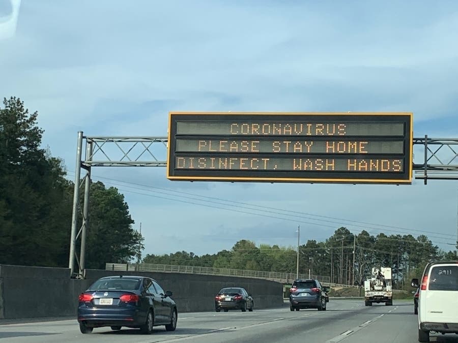 A sign on Ga. 400 warns drivers to stay home due to coronavirus.