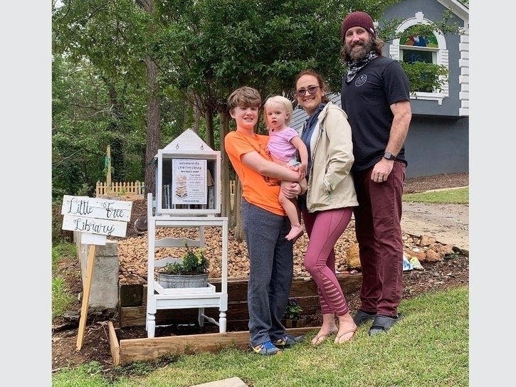 'The Little Free Library' is in front of the Ellis house. Left to right are Presley, Wilson Rose, Samantha and Joshua Ellis. 