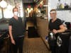 Staffers at 1920 Tavern in Roswell wear face masks Monday after Gov. Kemp allowed Georgia restaurants to reopen under coronavirus guidelines.
