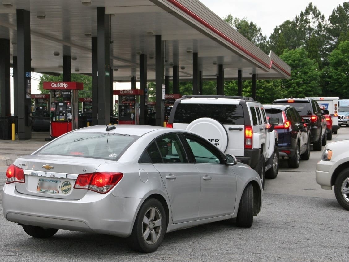 Drivers line up to fill up their gas tanks in Gwinnett County on Tuesday night.