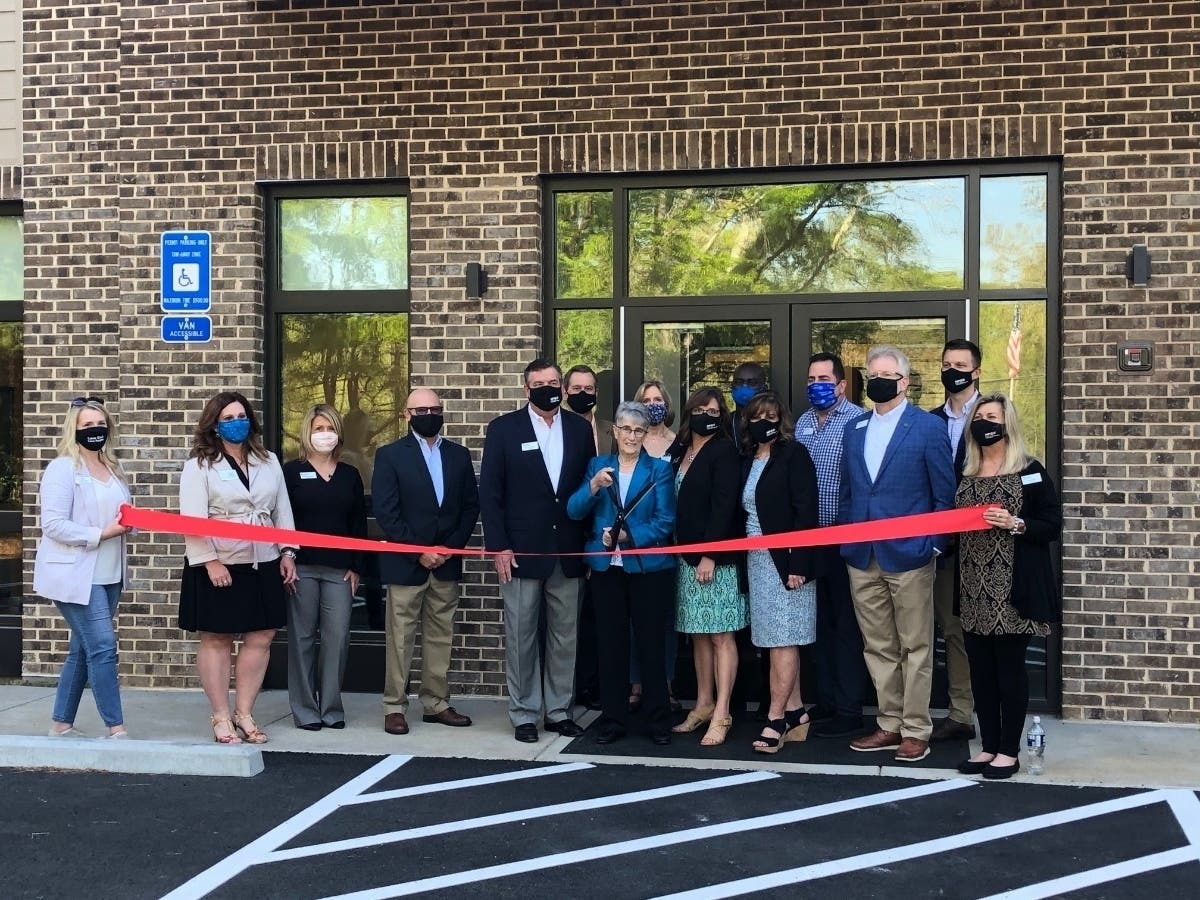 Long-time North Fulton Community Charities Executive Director Barbara Duffy, who retired at the end of 2019, cut the ribbon on the new Barbara Duffy Center, named in her honor.