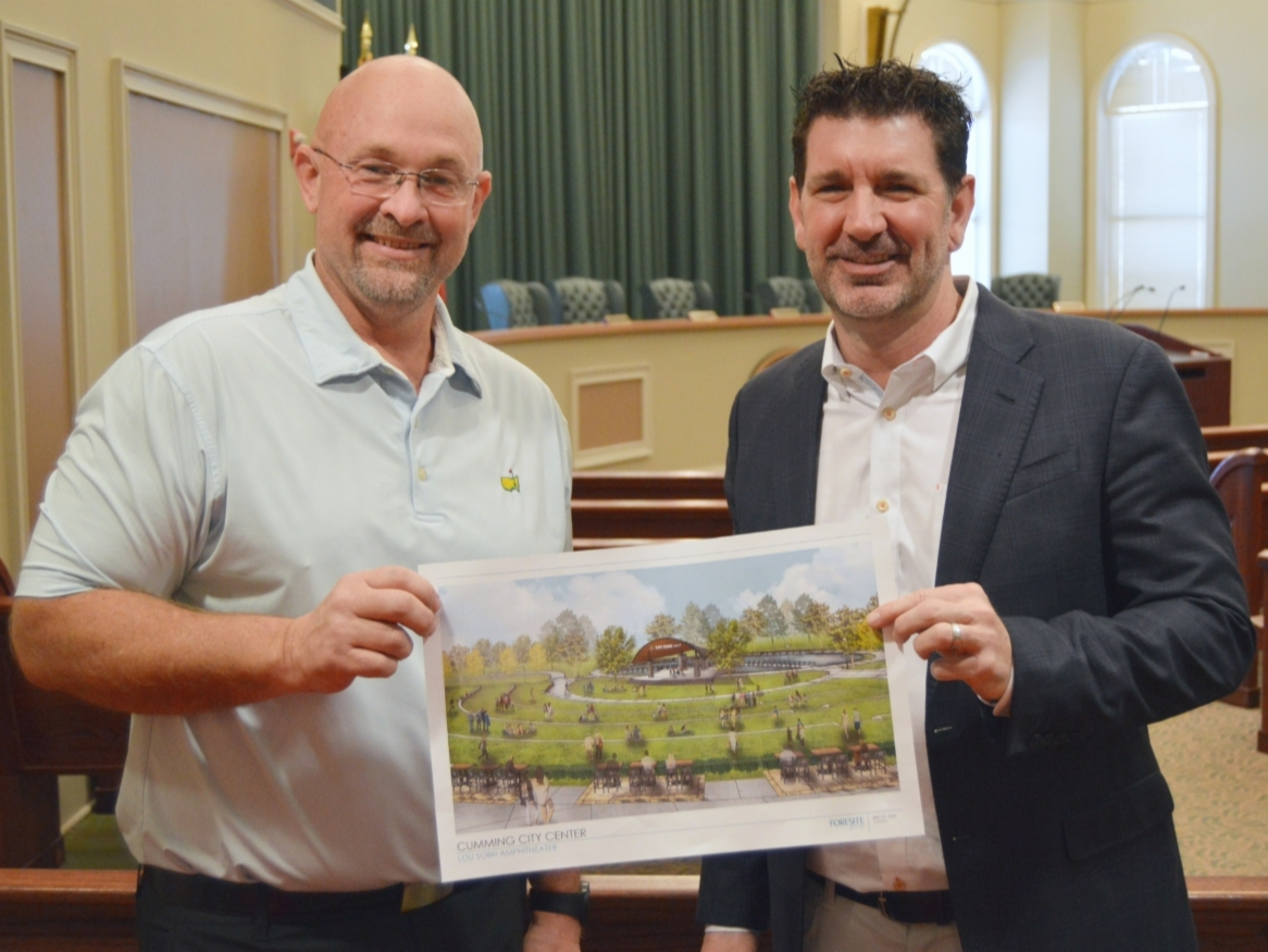 Mike Sobh, who co-owns two Lou Sobh Automotive Group dealerships, poses with Mayor Troy Brumbalow.