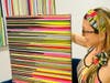 Artist and designer Marla Beth Enowitz sports pieces from the Marla Beth Designs x Mirame collection alongside her painting that inspired the new line of activewear.
