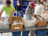 Volunteers at the Hillside Food Outreach warehouse sort food for upcoming deliveries.